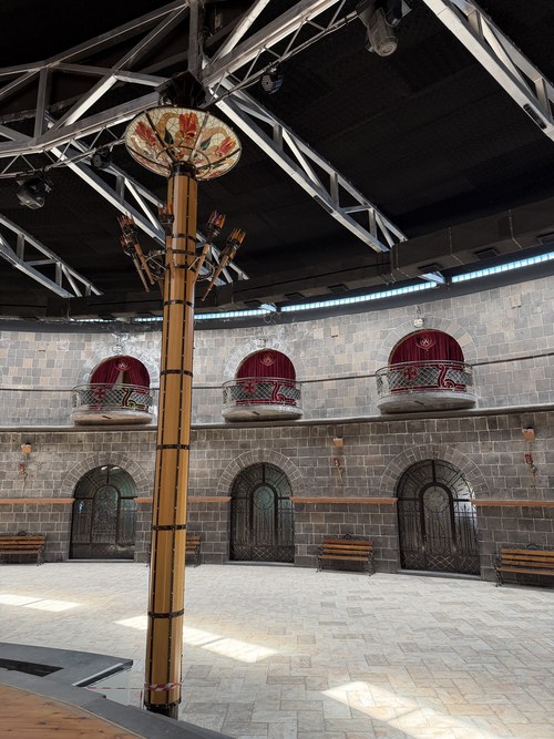 A decorative pillar rising in the curved stone courtyard of the restored fortress, the Black Fortress, Armenia