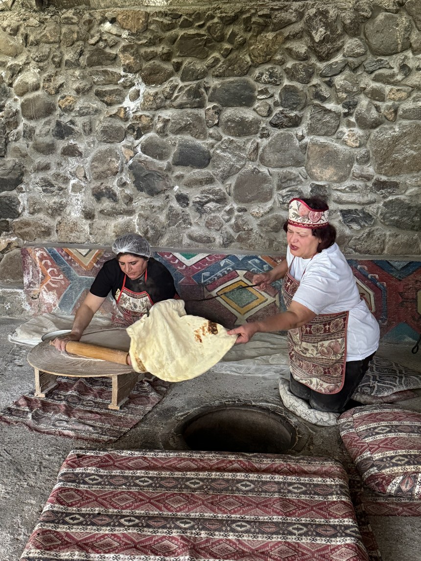 Lavash baking demonstration beside an underground oven, Armenia