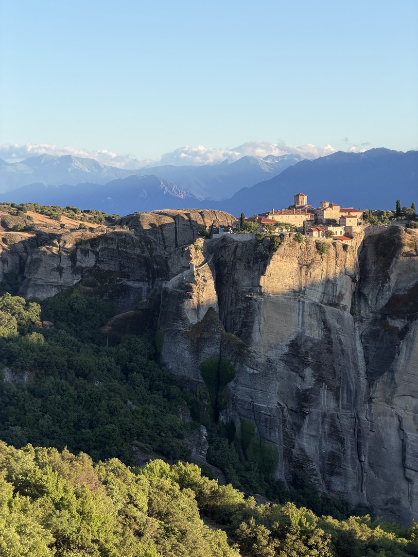 Monastery atop a sheer cliff in evening light, Main Observation Deck of Meteora, Greece