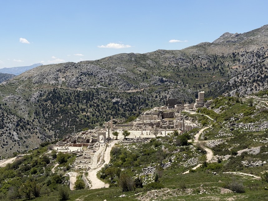 Ruins with columns and stone paths spread across a mountain slope, Sagalassos, Türkiye