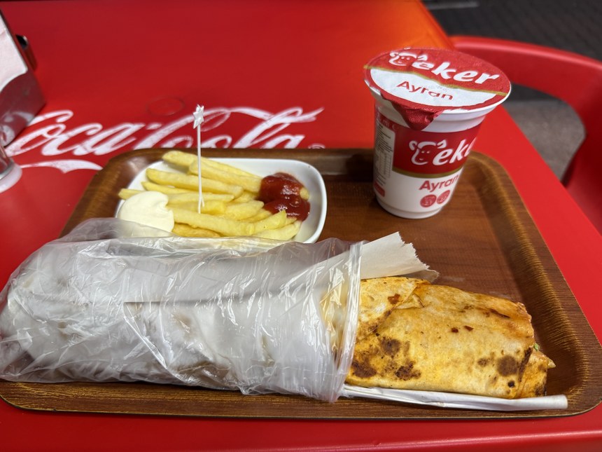 Wrapped durum with fries, ketchup, mayonnaise and a cup of ayran on a wooden tray, Üstat lokantası, Turkiye