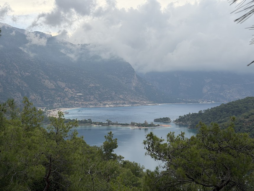 Cloudy view down to the Blue Lagoon and the beach at Ölüdeniz between forested hills, Lycian Way, Turkiye